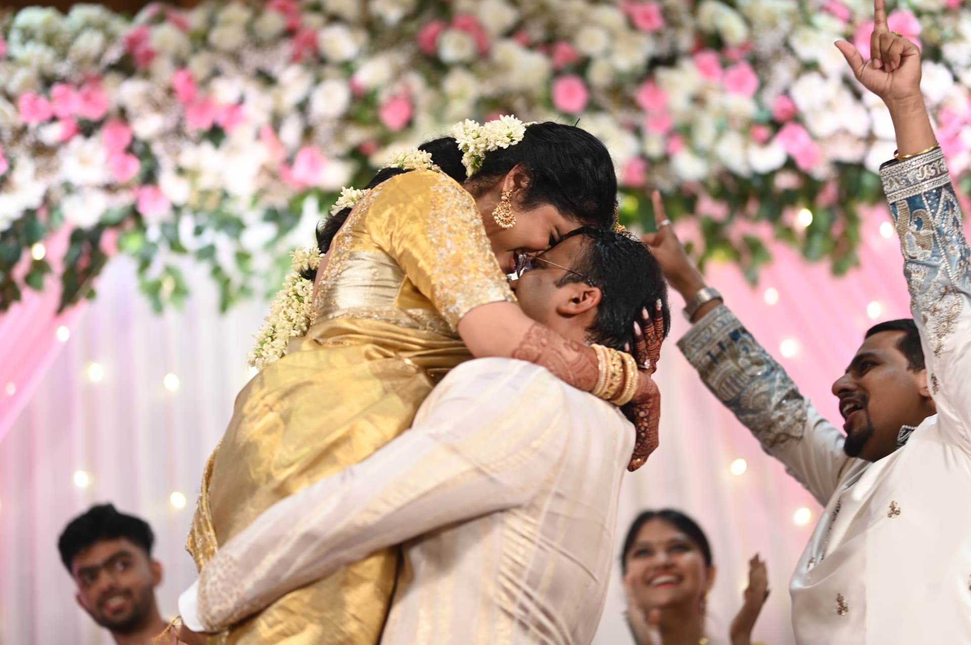 Sahil lifting Samiksha amid flowers and cheers