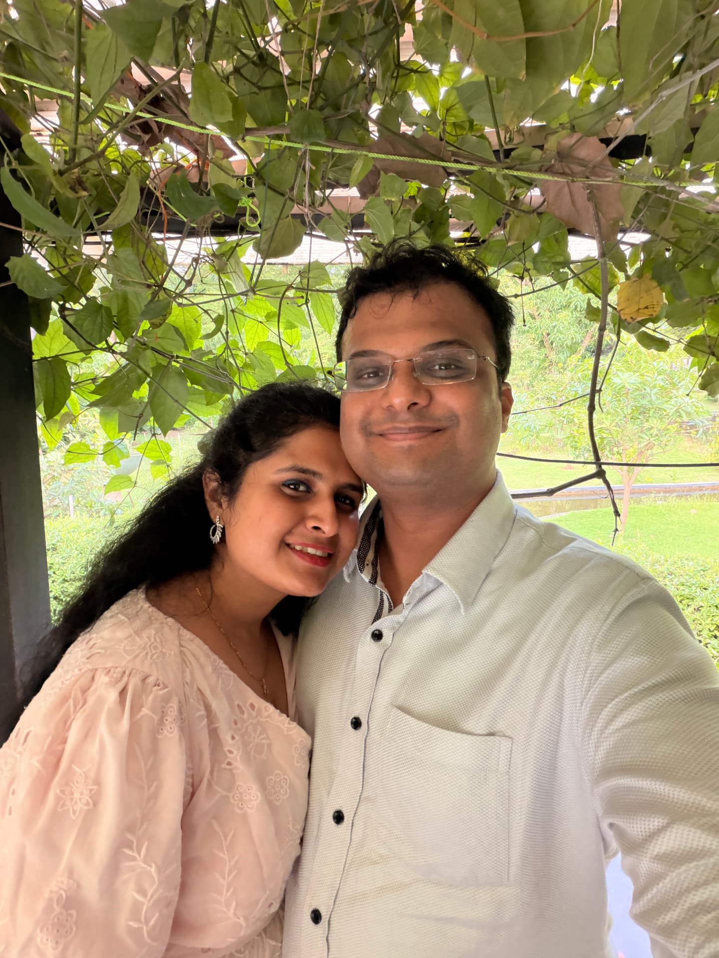 Sahil and Samiksha together beneath a leafy canopy